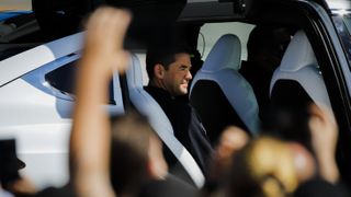 A man sits in a car.
